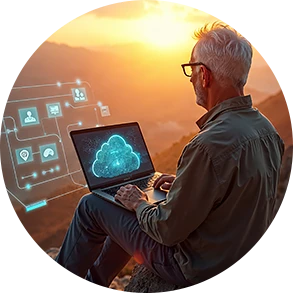 Person working on a laptop silhouetted against a sunset.